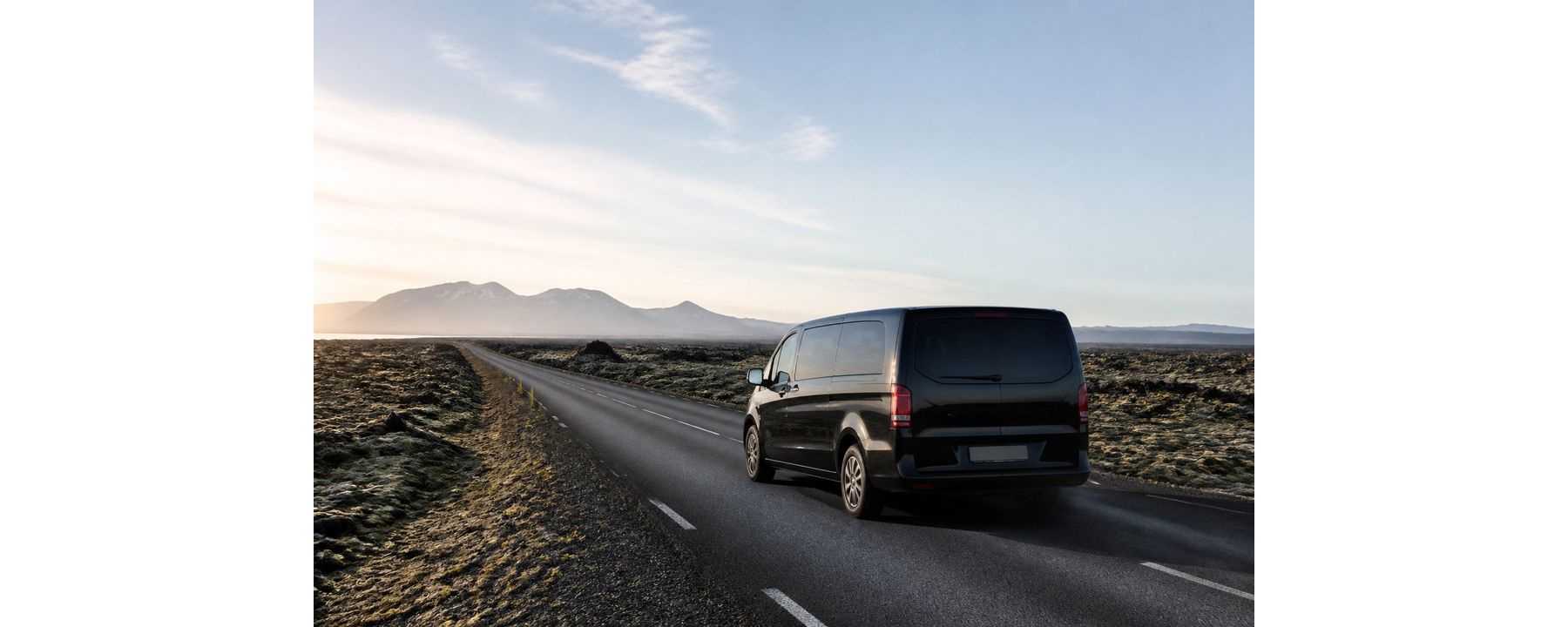 Illustrative unbranded passenger van traveling across Icelandic lava fields