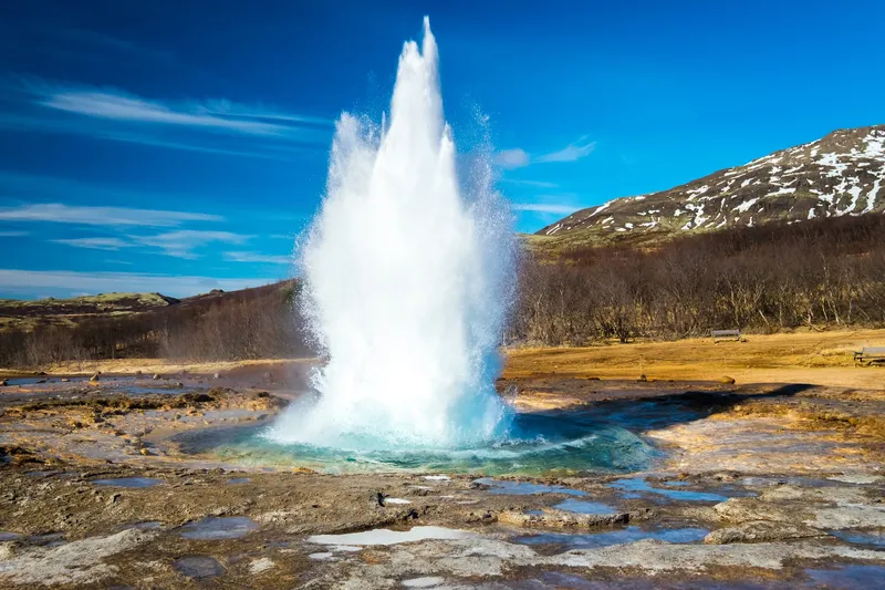 Geyser erupting in an Icelandic geothermal landscape