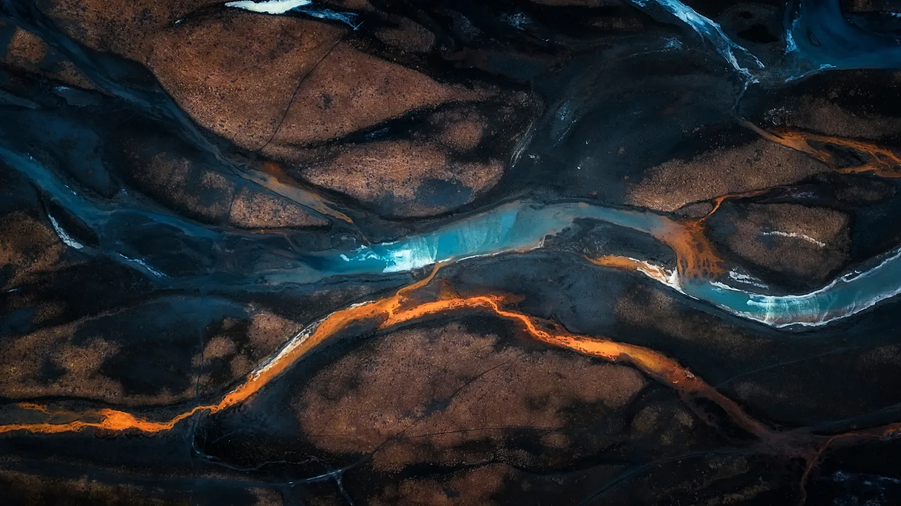 Braided glacial rivers flowing across Iceland’s volcanic landscape