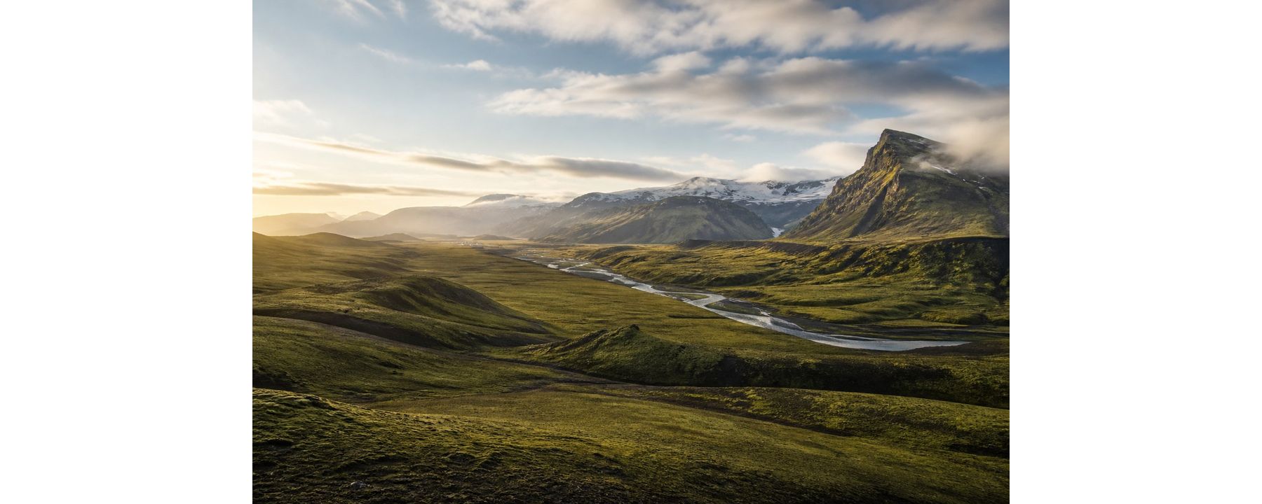 Broad Icelandic valley with mountains and a winding glacial river