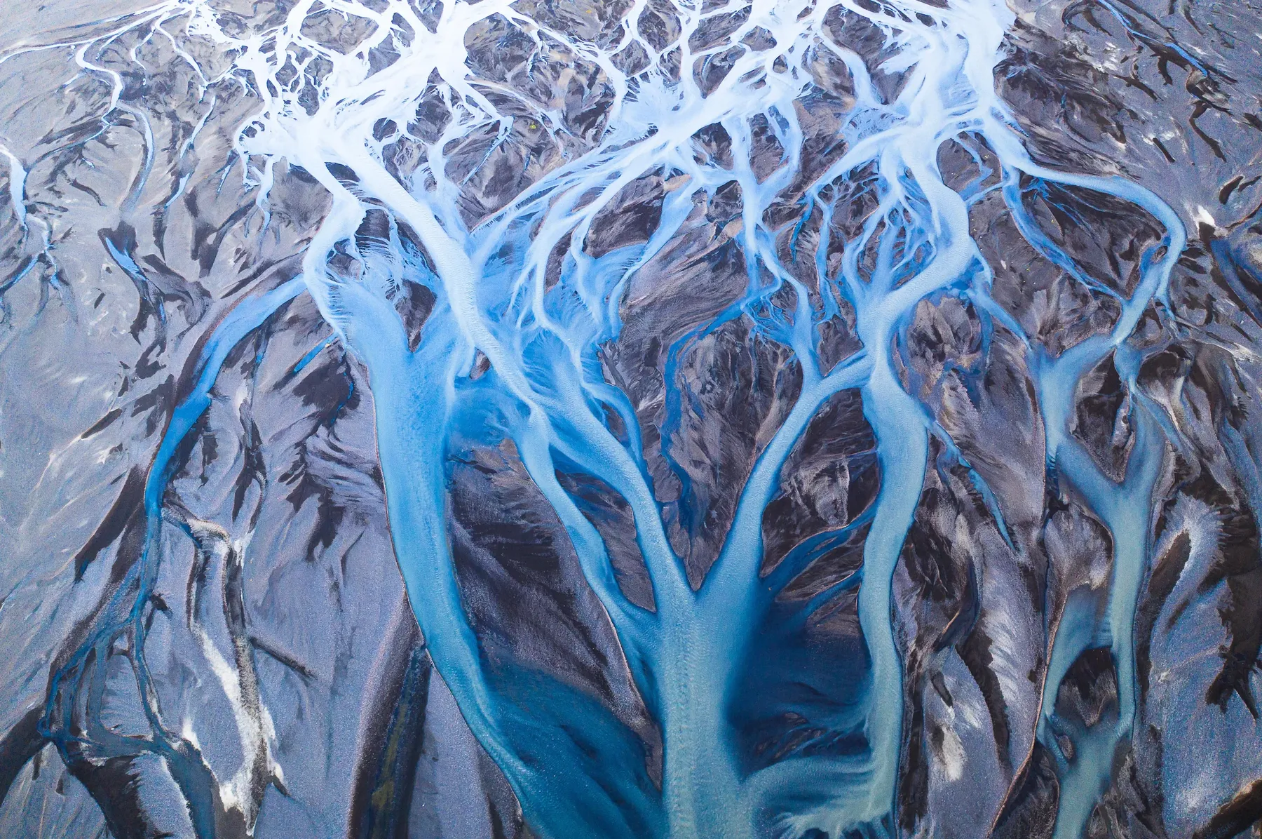 Interwoven glacial rivers creating patterns across Iceland