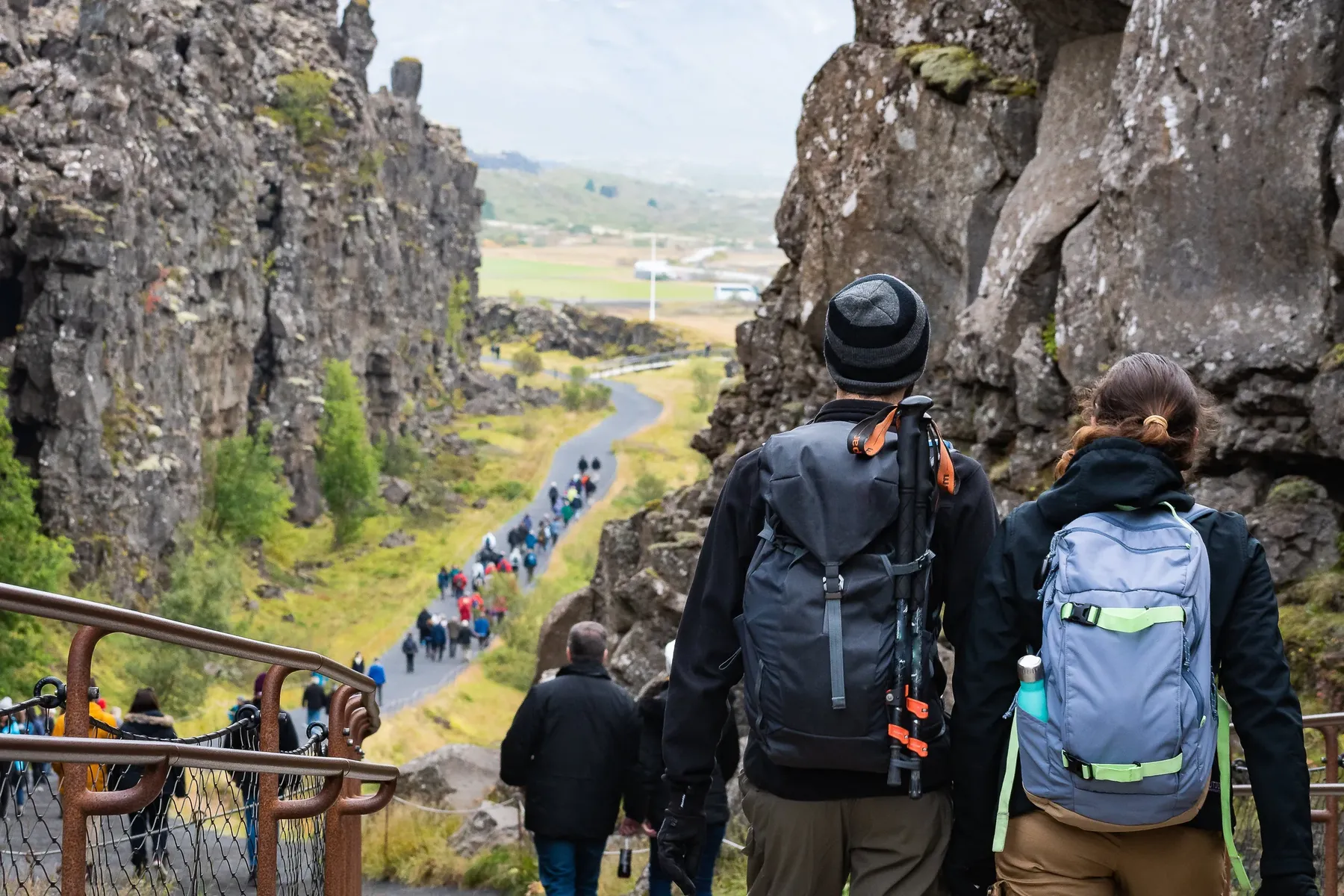 Travellers walking between the cliffs at Þingvellir